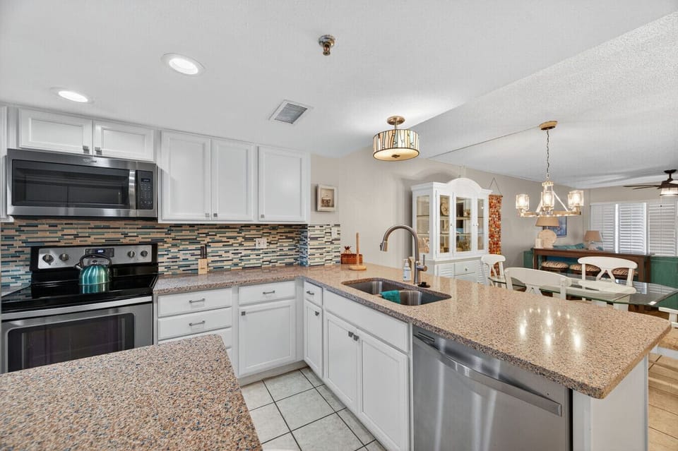 Well-equipped kitchen featuring ample counters and an open layout that flows into the living space.
