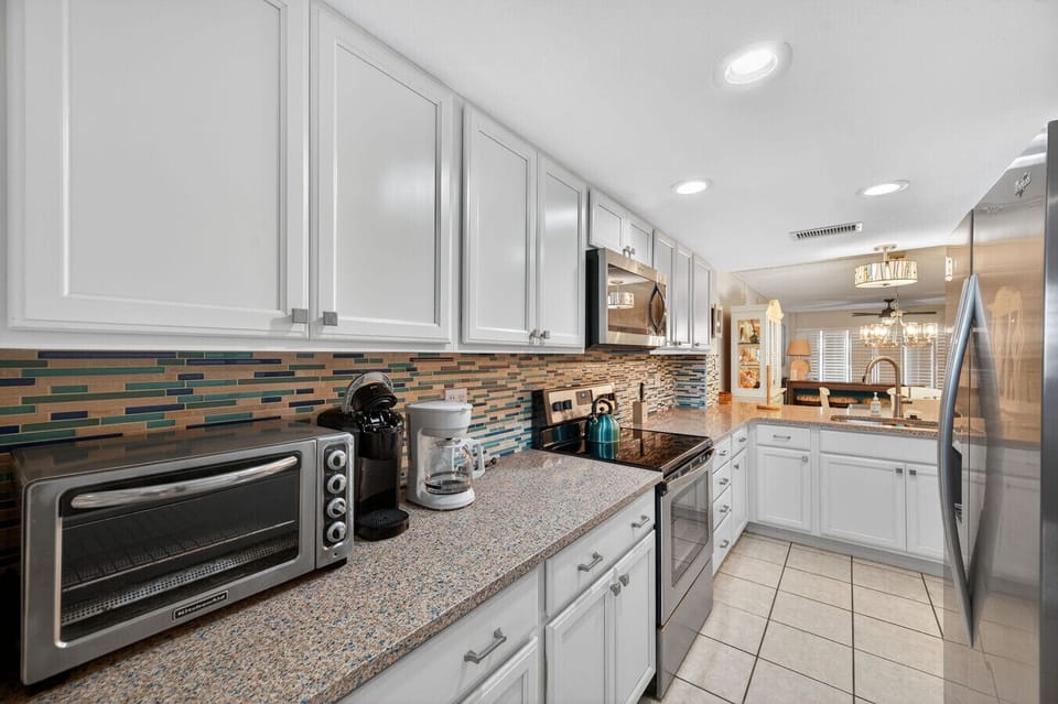 Fully loaded kitchen w/ modern appliances, tile backsplash, and everything needed to cook with ease.