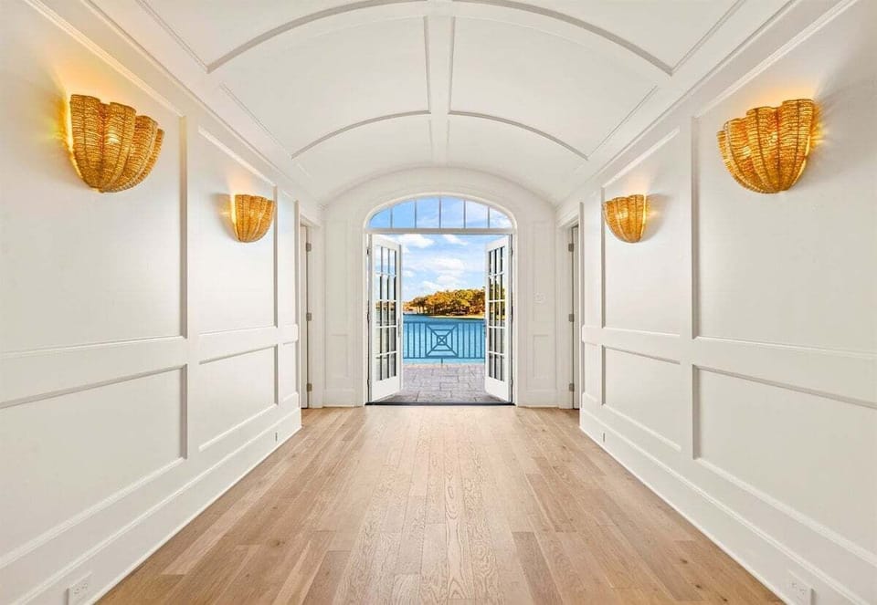 Grand entry hallway with arched ceiling and warm natural light.