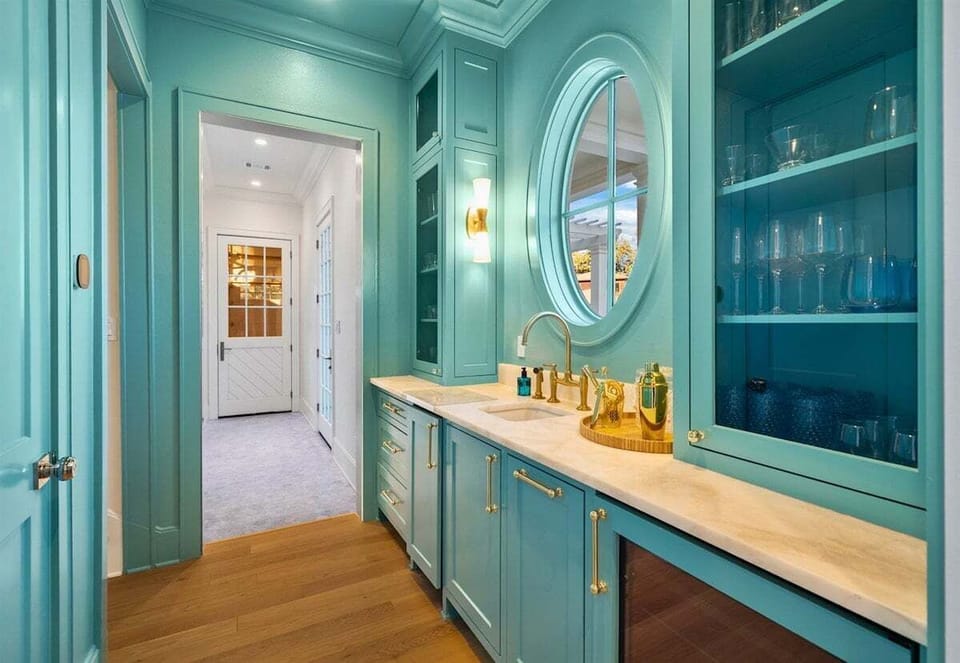 Bright teal chef's kitchen stocked with all you could need for a fun drink.