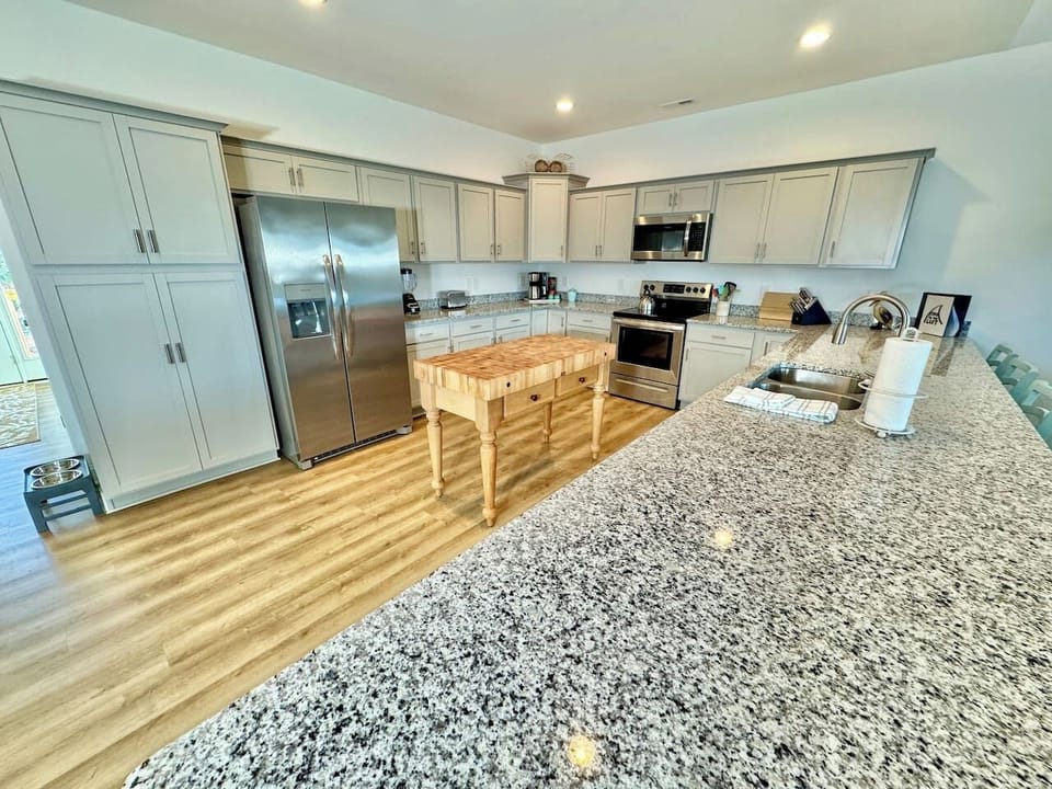 Enjoy cooking in this fully stocked kitchen with a custom island and ample bar seating. 