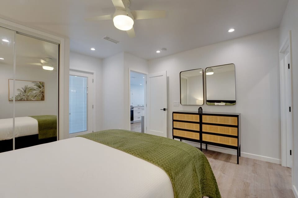 The primary bedroom has an en-suite bath, Smart TV, closet, ceiling fan, and patio access.