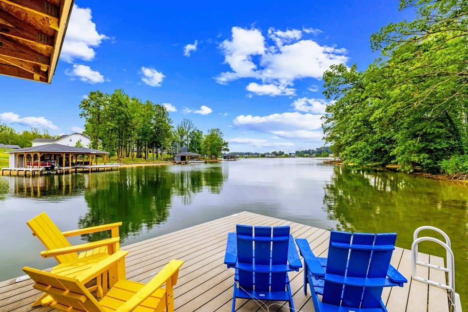 Dock - Pull up a chair and watch the cove open into wide water, framed by tall trees on both sides.