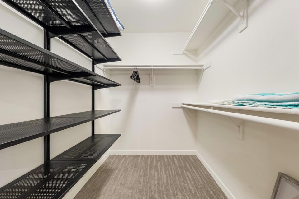 Spacious walk-in closet with ample shelving and hanging space for your