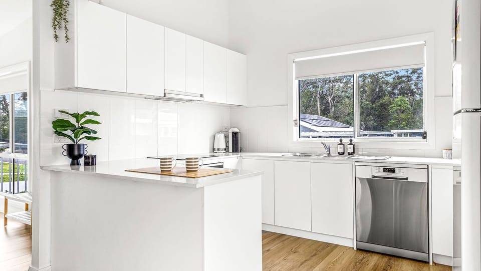 Modern kitchen with sleek white cabinets and stainless-steel appliances