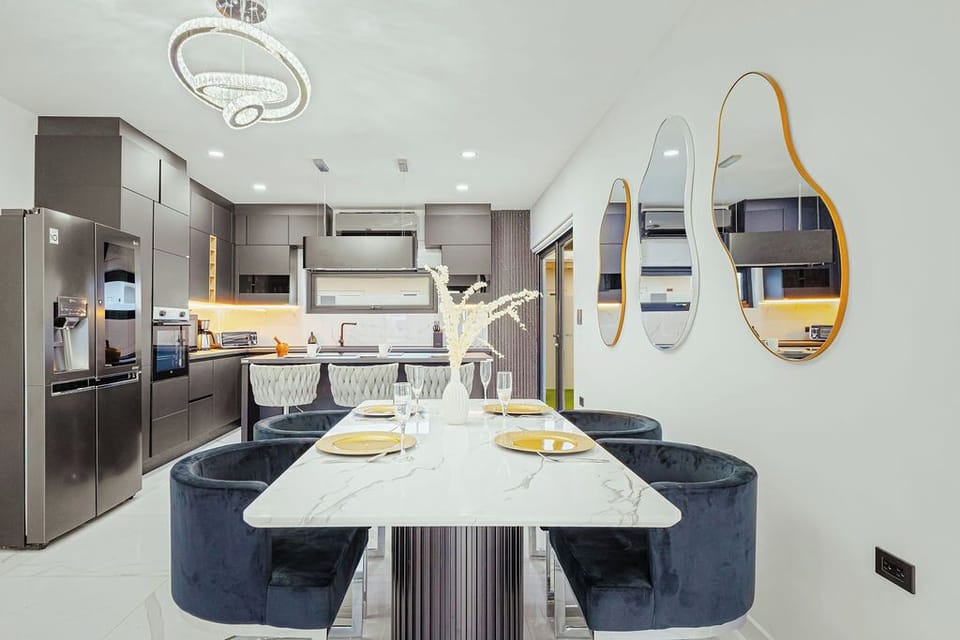 Gather around the dining table and share meals together in a cozy, open setting.