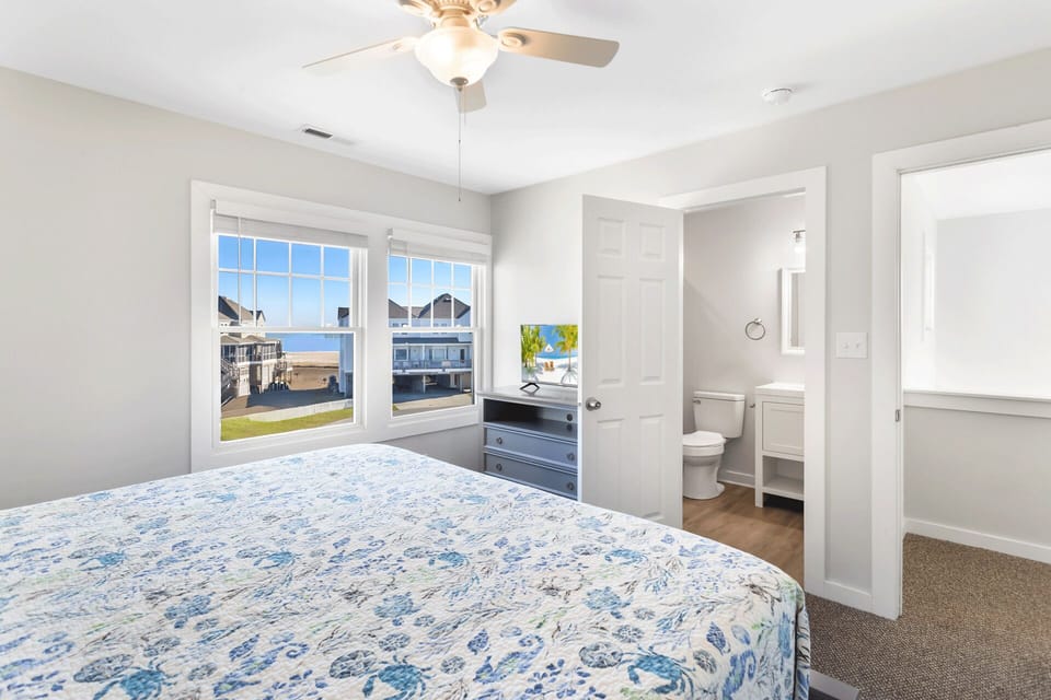 King Ensuite Bedroom:  Spacious primary bedroom featuring a king bed, comfortable furnishings, and easy access to a full bathroom.