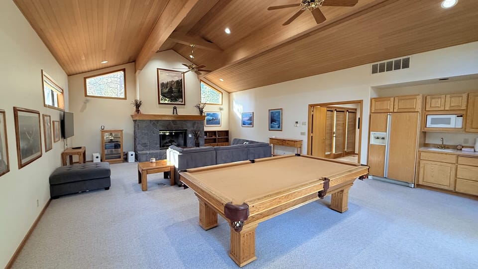 Pool table, TV and games along with a kitchenette and extra refrigerator.