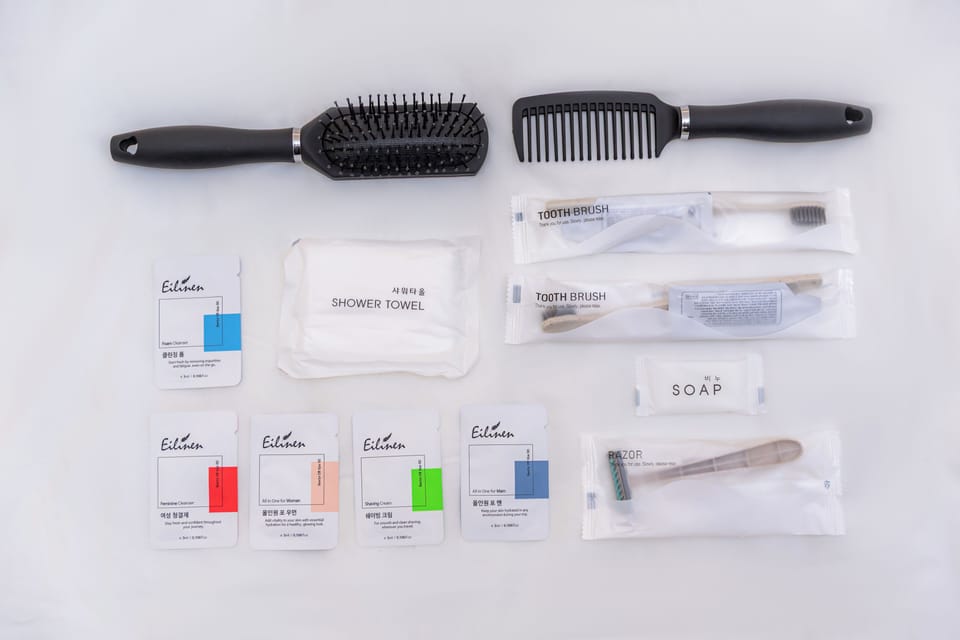 Shower, designer toiletries, hair dryer, slippers