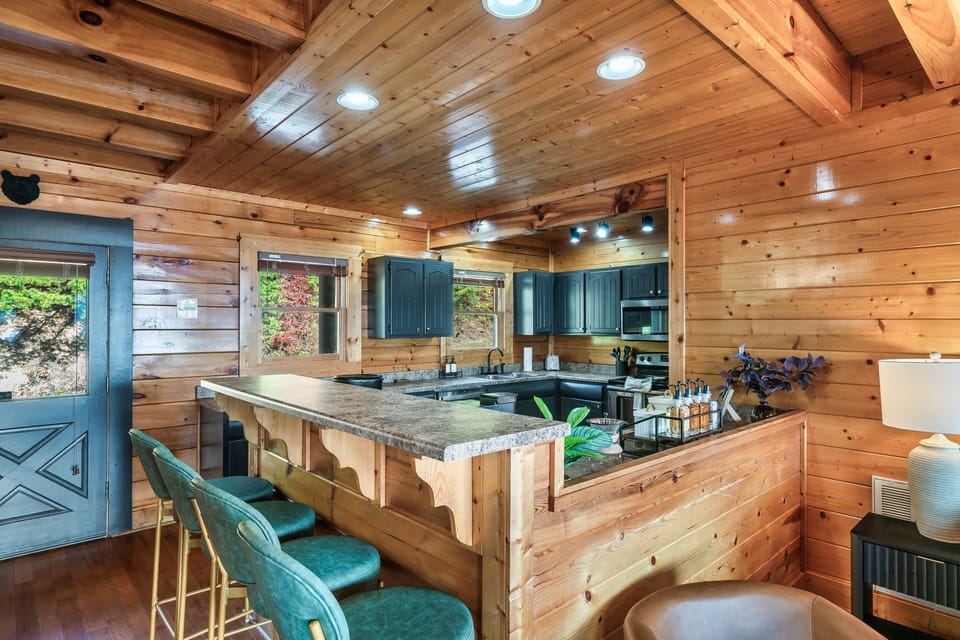 Kitchen with bar seating open to living area.