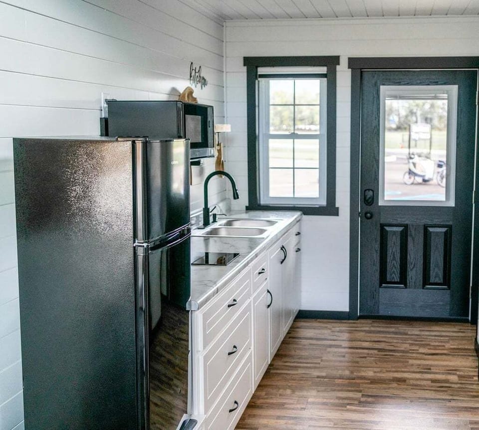 The kitchenette is equipped with a microwave, refrigerator, and hot plate.