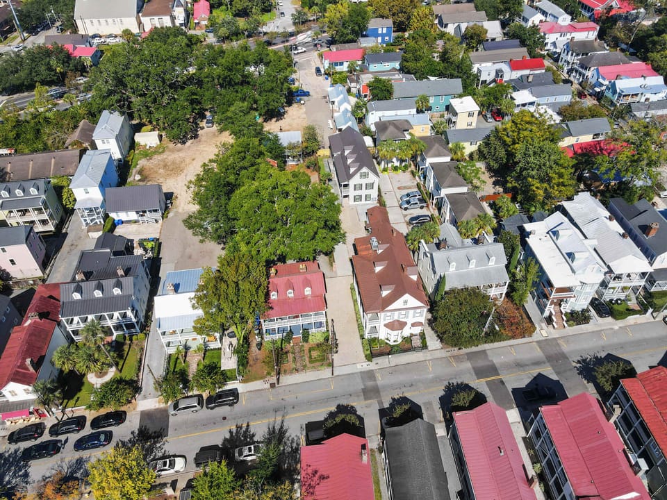 Aerial view that shows both houses on the property. There are 18 total bedrooms and 14.5 bathrooms between them both. 