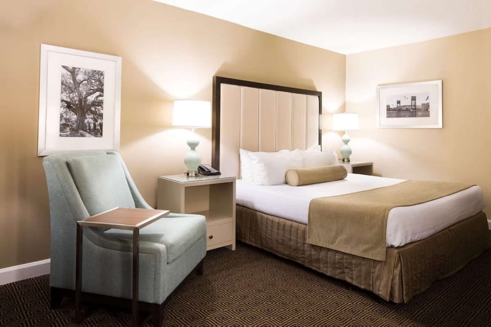 Warm guest room with plush king bed and armchair