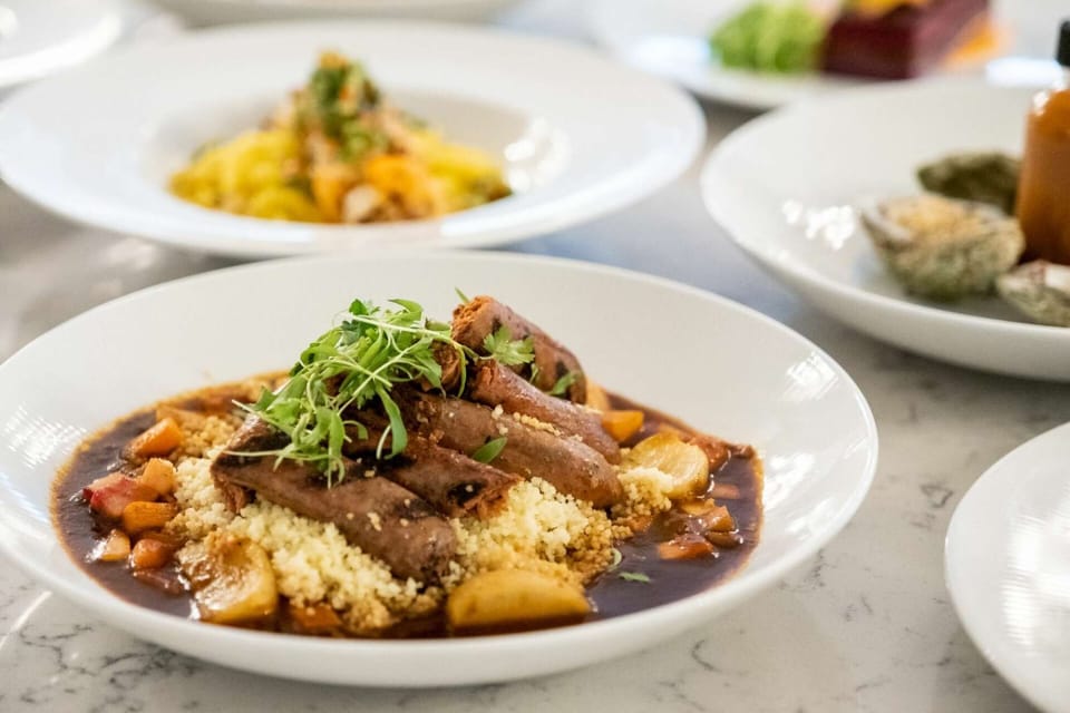 Braised meat with couscous and vegetables in rich sauce