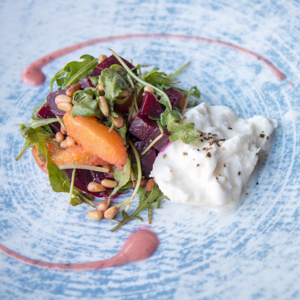 Beet and citrus salad with arugula, pine nuts, and whipped cheese