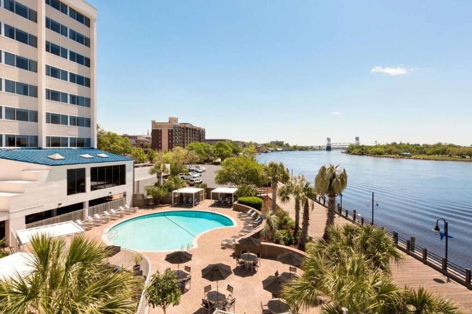 Outdoor pool with riverfront view and lounge seating
