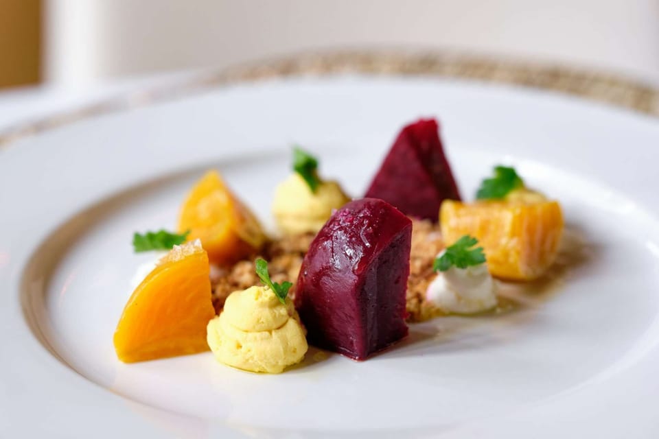 A gourmet beet and citrus salad plated with artistic precision