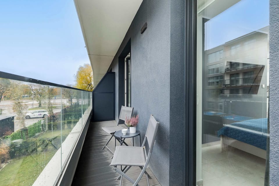 Balcony view with a glass railing, offering a lovely spot to enjoy fresh air and city views.