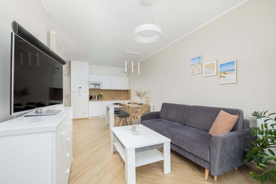 Cosy living room with a cozy sofa and access to a private balcony, perfect for relaxing after a day of sightseeing.