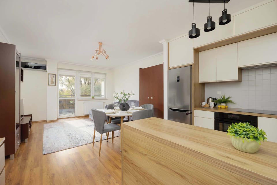 The dining area with elegant lighting and a large table is perfect for morning breakfasts and long dinners with loved ones.