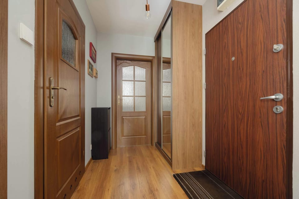 Spacious hallway with a large wardrobe and wooden floor welcomes guests with elegance and order.