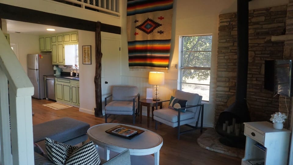 Take a moment to settle into the living room, arranged with a plush couch, 2 cozy chairs, candlelit ambiance from the fireplace, and an HDTV ready for movies, sports, or your favorite shows.