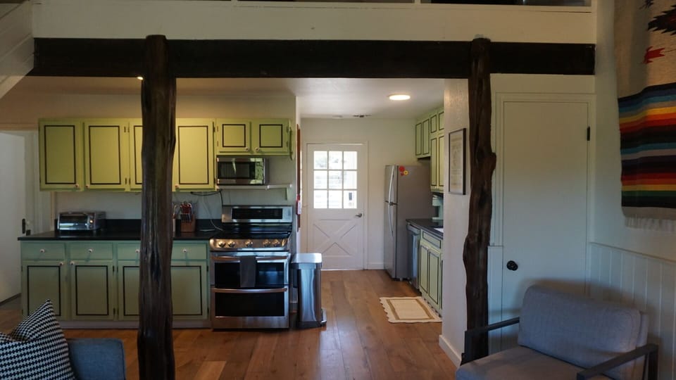 The kitchen may be compact, but it’s fully stocked with essentials—microwave, blender, toaster, dinnerware, and cookware—making it easy to prepare everything from quick snacks to full home-cooked meals.