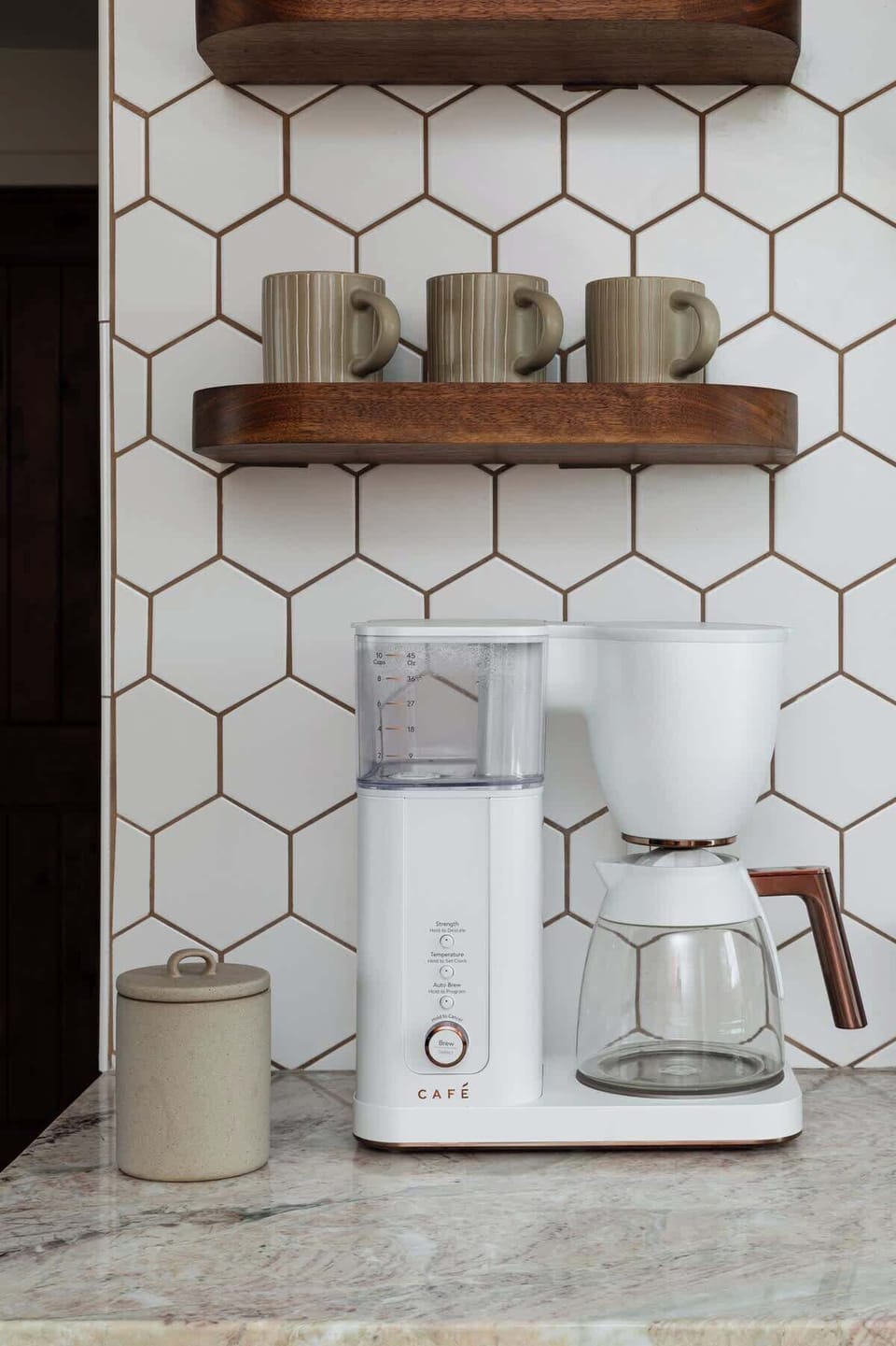 Café drip coffee maker with Wonderlake coffee, sugar, and creamer provided.