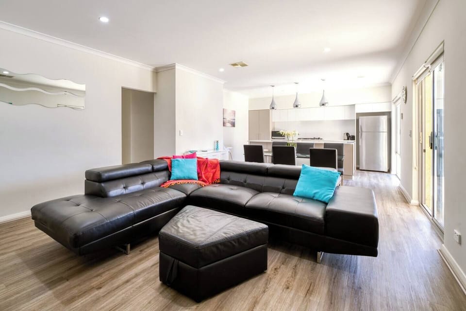 A large sofa within the living room encourages you to relax with some TV and the comfort of central cooling.
