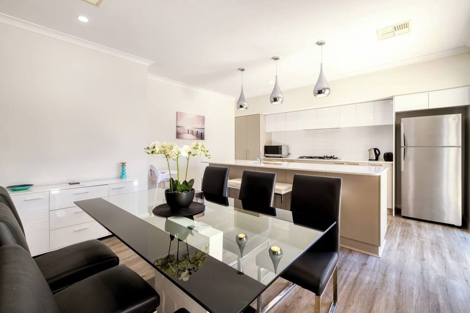 The open plan kitchen and dining area flows directly to the patio creating a seamless transition with the outdoors.

