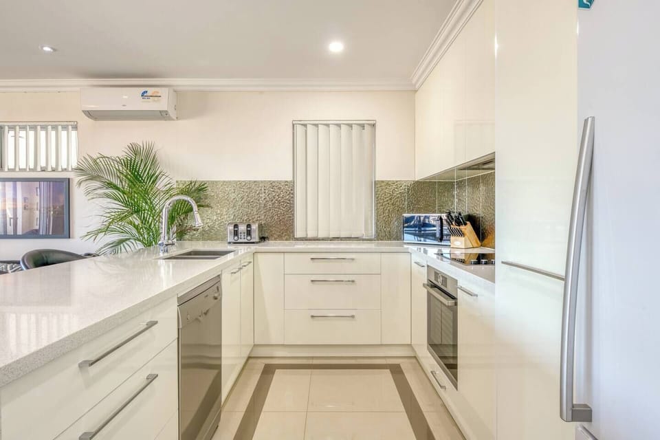 The well-equipped kitchen features modern amenities and sleek design, perfect for creating homemade meals.
