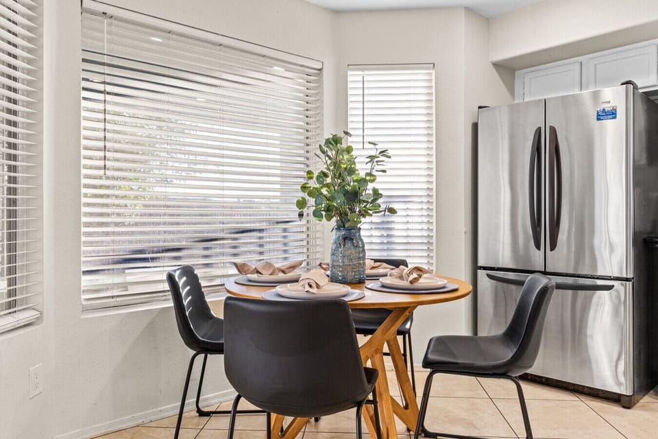 Round dining table — seats the whole group, no one at the end.