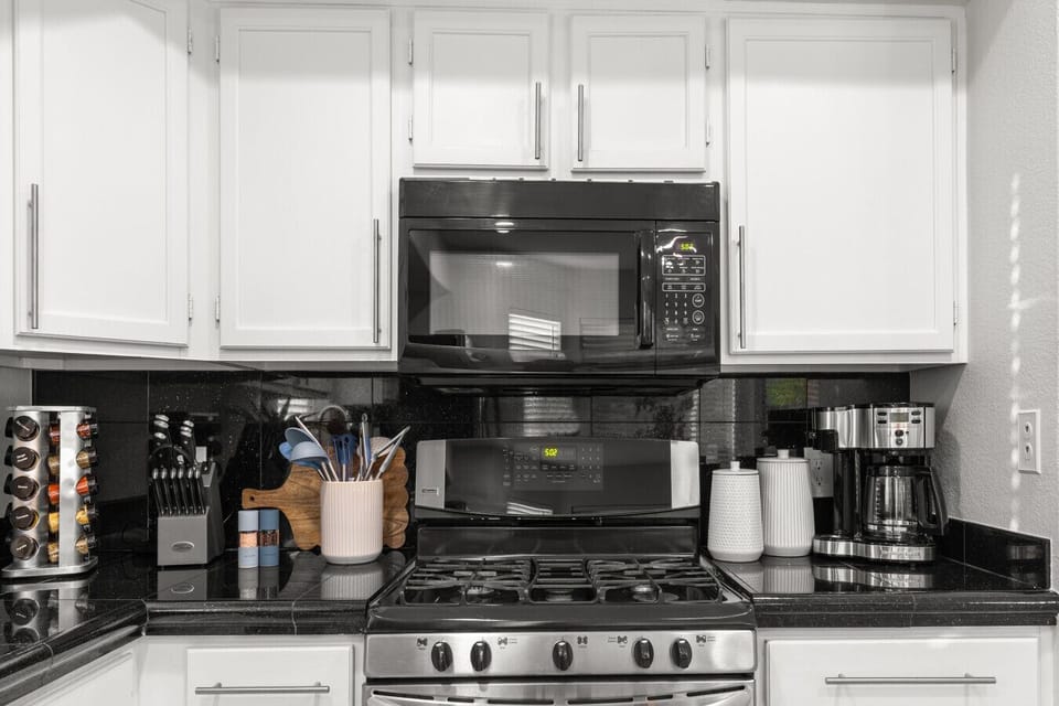 Fully stocked counter — Keurig, drip coffee, knife set, spices.