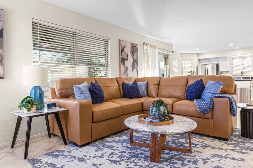 L-shaped leather sectional — seats the whole group comfortably.