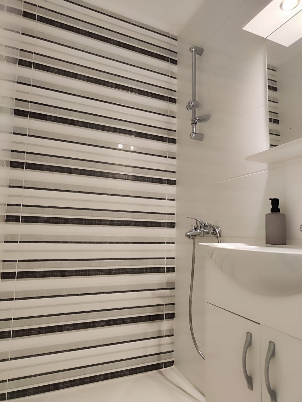 Shower, hair dryer, slippers, towels