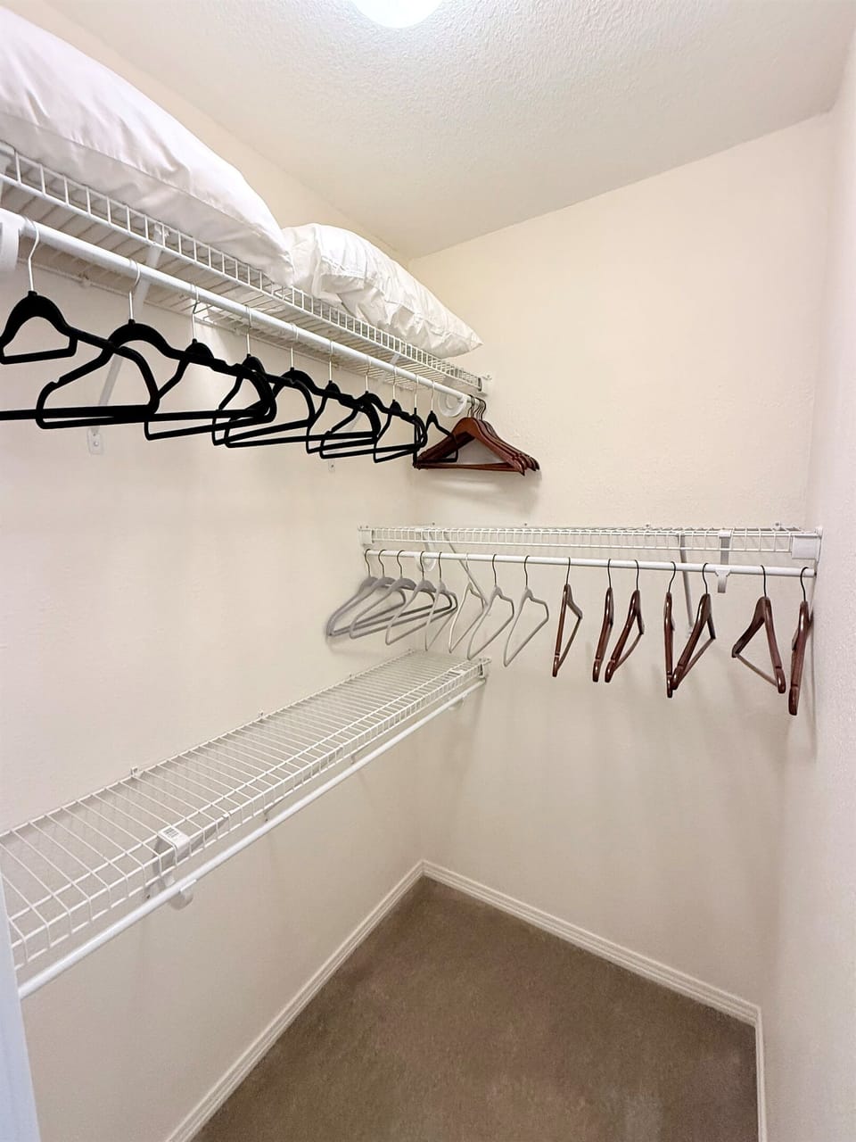 Walk in closet in primary bedroom.