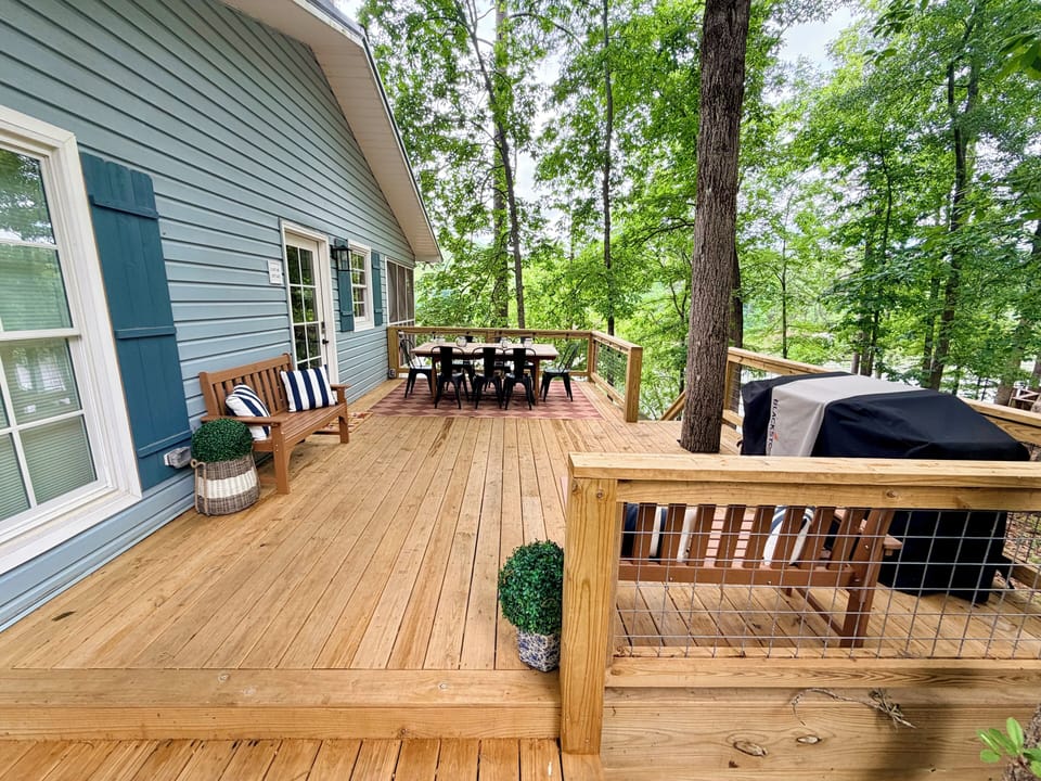 The entrance to house is on the side porch along with grill & an eating area.