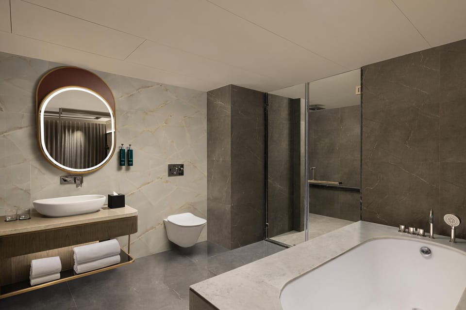 Suite, 1 King Bed, Refrigerator (Ambassador) | Bathroom | Eco-friendly toiletries, hair dryer, bathrobes, slippers