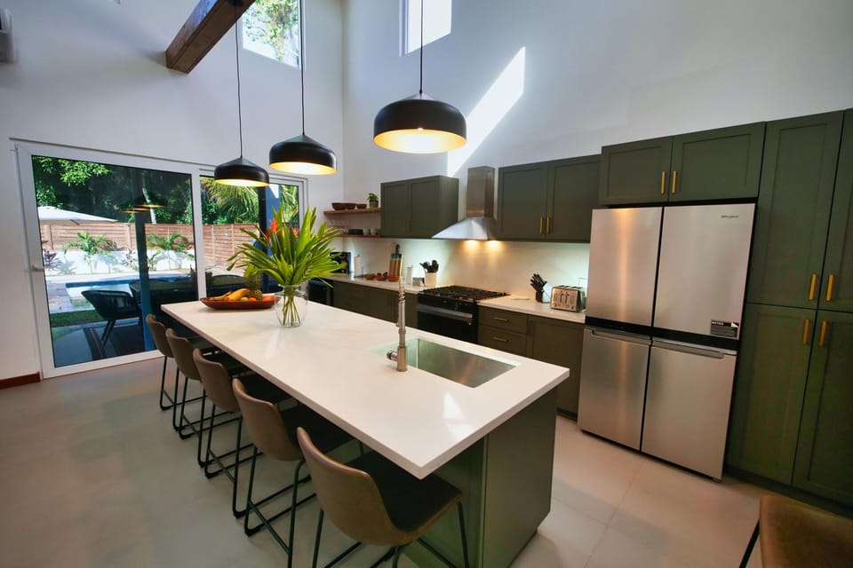 Spacious kitchen with sleek island seating and natural light