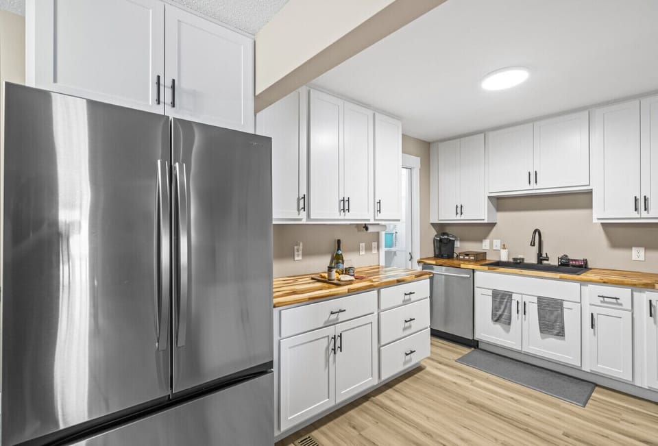 Kitchen | Sleek White Cabinets, Butcher Block Counters & Stainless Steel Appliances