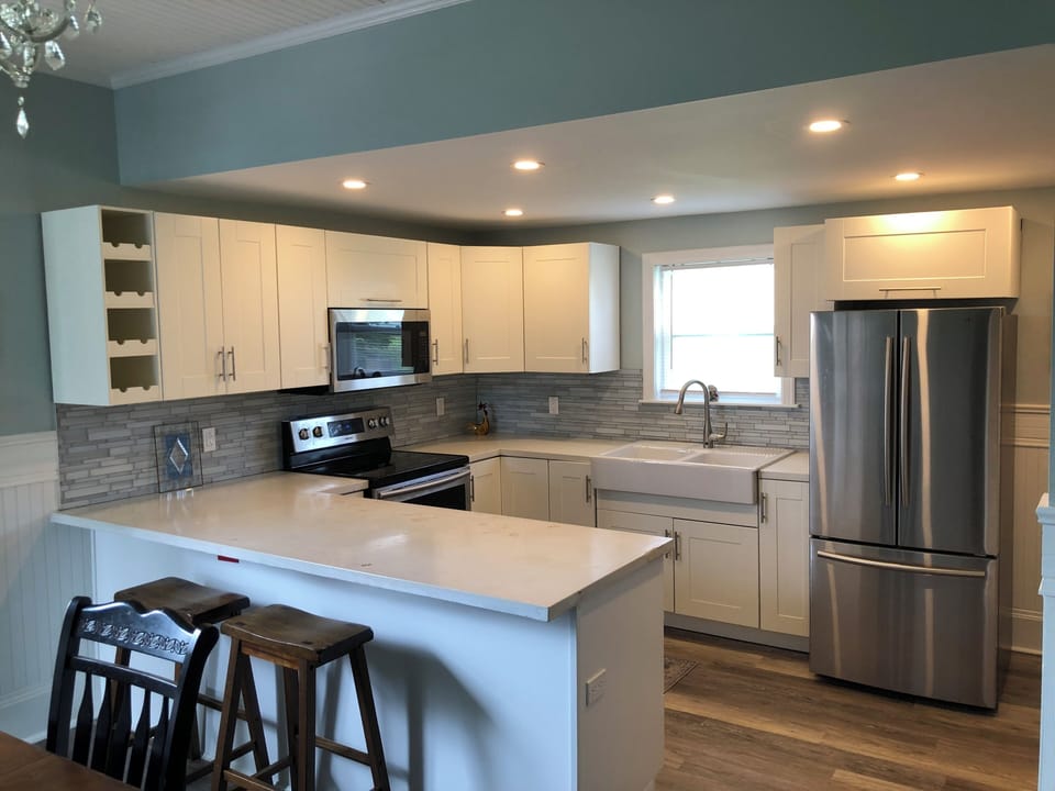 Modern kitchen with concrete countertops and stainless steel appliances. 