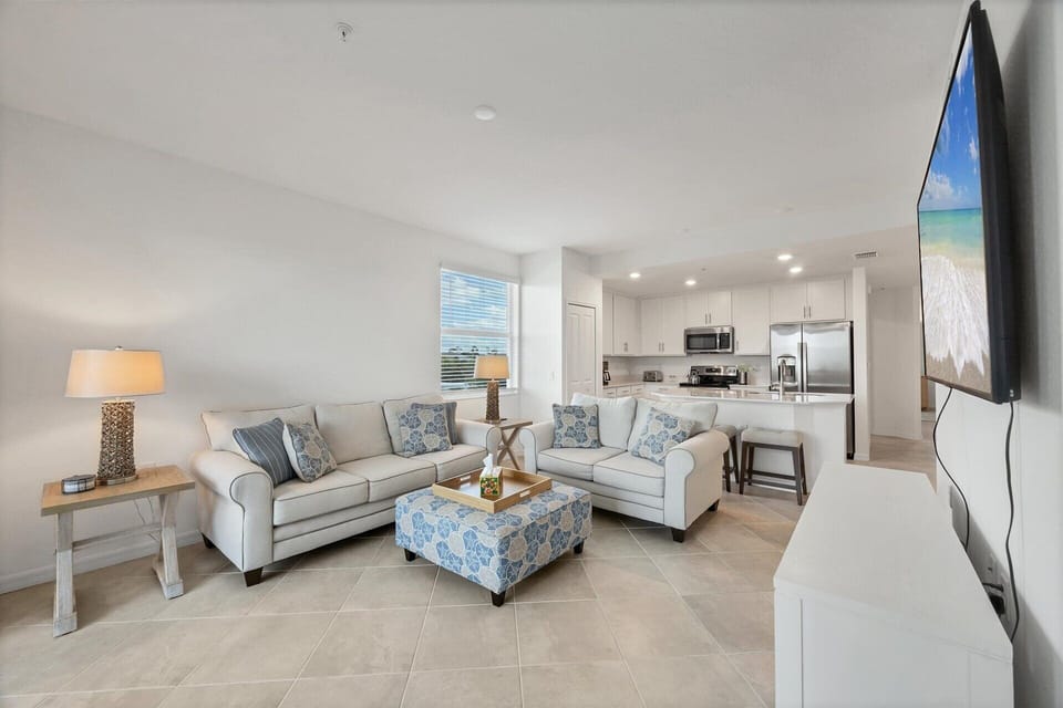 Bright, open living space. Living room overlooks the nature preserve and features ample seating and 65-inch Smart TV
