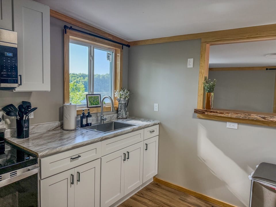 Bright updated kitchen with scenic window views and stylish finishes
