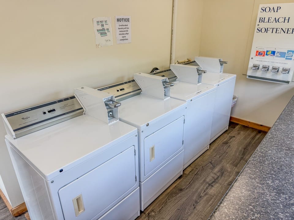 Convenient on-site laundry room with multiple dryers and supply vending