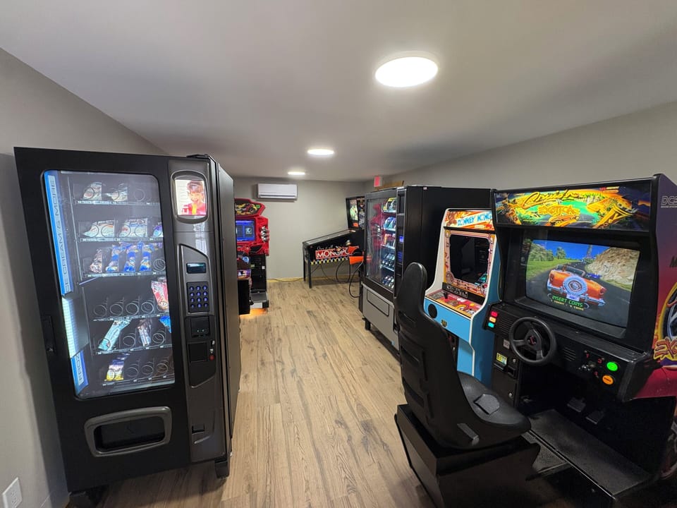 24/7 game room with arcade games, vending machines, and ATM