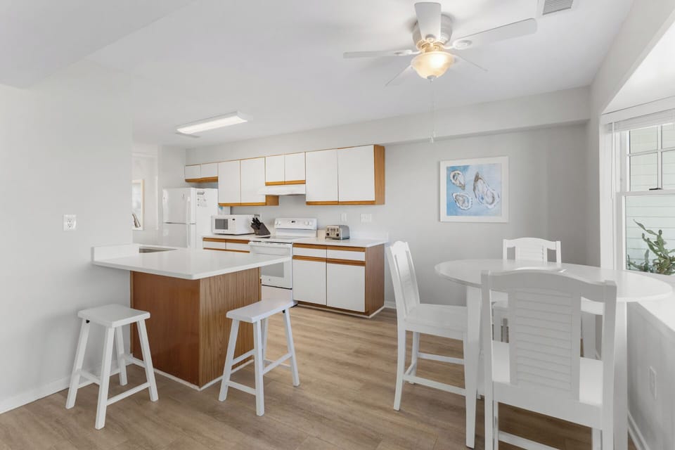 Main Level: Breakfast bar, gaming table, and kitchen are perfect for family meals.