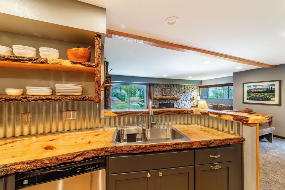 Kitchen overlooking living room and scenery.