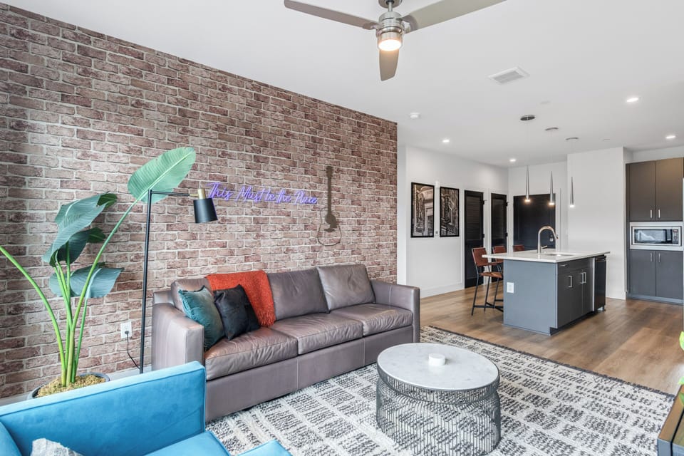 Open-concept living and dining area with large windows and natural light.