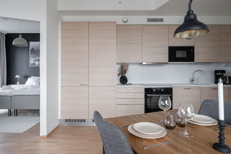 The fully equipped open kitchen has everything you need to prepare your favorite meals: a dishwasher, stove, oven, microwave, coffee maker, kettle, and a full set of cookware, dishes, and utensils.