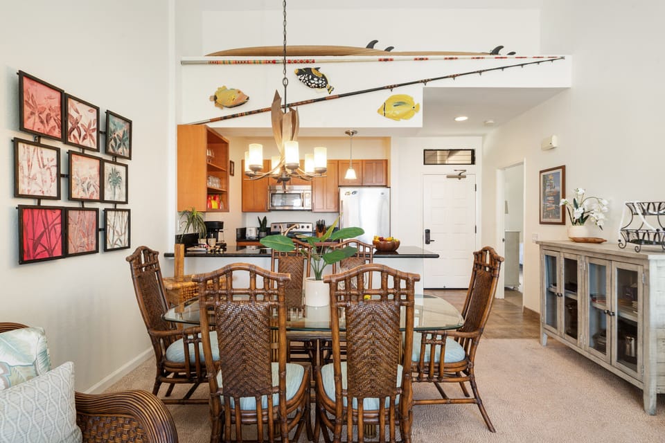Dine in style with a tropical-inspired dining set and open kitchen layout, creating the perfect space for shared meals and conversation.